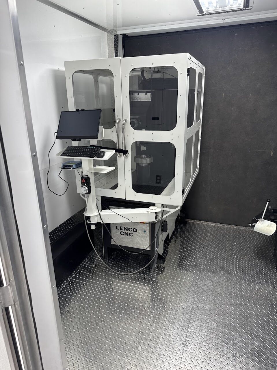Enclosed CNC wheel lathe with control computer inside the Rim Revival trailer